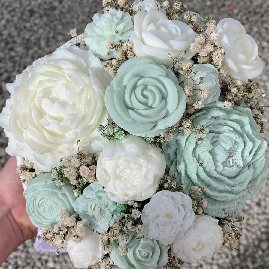 Our handmade candle bouquet in soft blue, green & white, featuring chocolate and